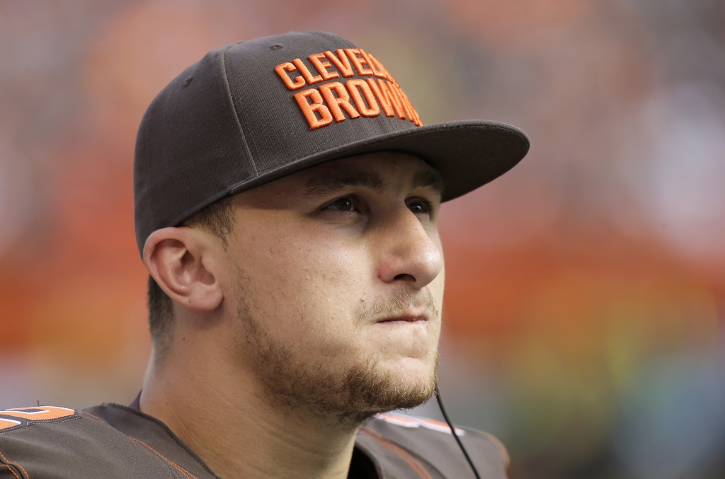 Cleveland Browns quarterback Johnny Manziel watches from the sidelines during the second half of an NFL football game against the Oakland Raiders in Cleveland. When an NFL team is forced to use its backup quarter