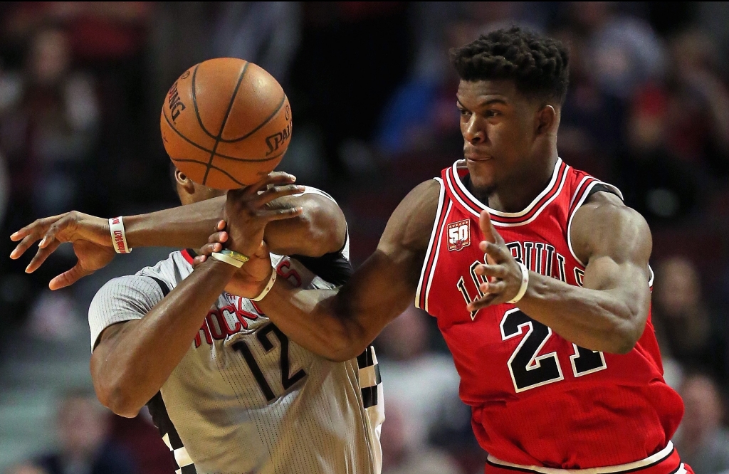 Bulls wing Jimmy Butler right battles Rockets center Dwight Howard for the ball