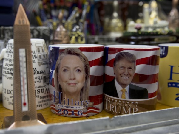 Coffee mugs for sale with the images of Democratic presidential candidate Hillary Clinton and Republican presidential candidate Donald Trump sit side by side on a shelf of a souvenir stand at the corner of Constitution Avenue NW and 17th Street NW in Wash