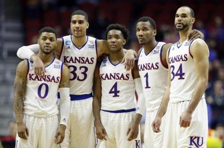 Kansas&apos Frank Mason III, Landen Lucas, Devonte&apos Graham, Wayne Selden Jr. and Perry Ellis gather during the second half of a second-round men's college basketball game against Connecticut in the NCAA Tournament Saturda