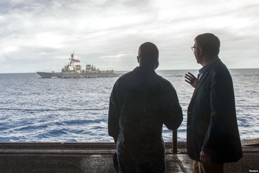 FILE- U.S. Secretary of Defense Ash Carter speaks with U.S. Navy Cmdr. Robert C. Francis Jr. as Carter visited the USS Theodore Roosevelt aircraft carrier in the South China Sea. US Ambassador to Asean Nina Hachigian called US freedom of navigation