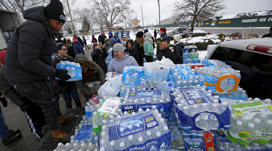 Volunteers distribute bottled water to help combat the effects of the crisis when the city's drinking water became contaminated with dangerously high levels of lead in Flint Michigan