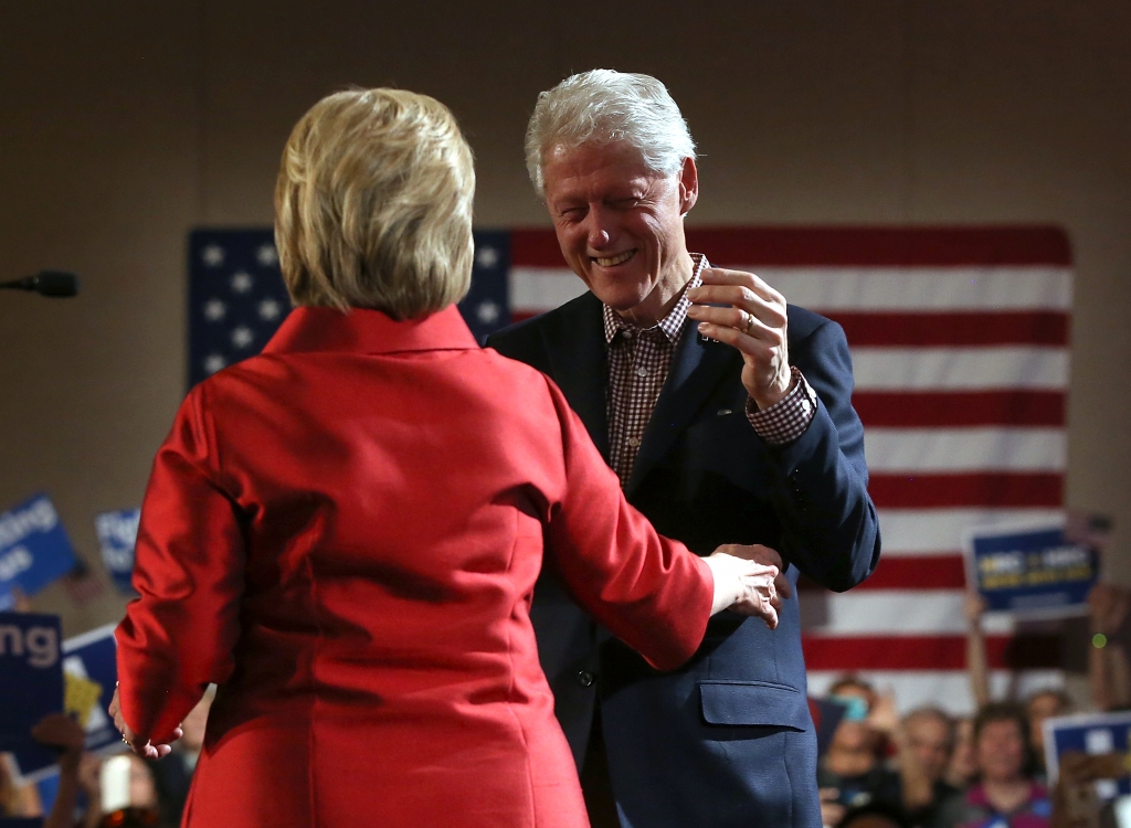 Democratic presidential candidate former Secretary of State Hillary Clinton embraces her husband former U.S. president Bill Clinton during a caucus day event at Caesers Palace