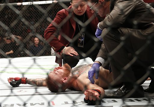 Conor Mc Gregor recovers shortly after a second round-submission to Nate Diaz during their UFC 196 welterweight mixed martial arts match Saturday