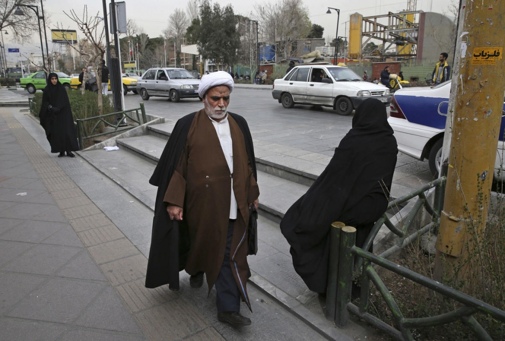 Credit The Associated Press         
     A clergyman make his way in a sidewalk in downtown Tehran Iran Sunday Feb. 28 2016