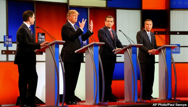 Republican presidential candidate businessman Donald Trump second from left gestures as Sen. Marco Rubio R-Fla. Sen. Ted Cruz R-Texas and Ohio Gov. John Kasich watch him a Republican presidential primary debate at Fox Theatre Thursday