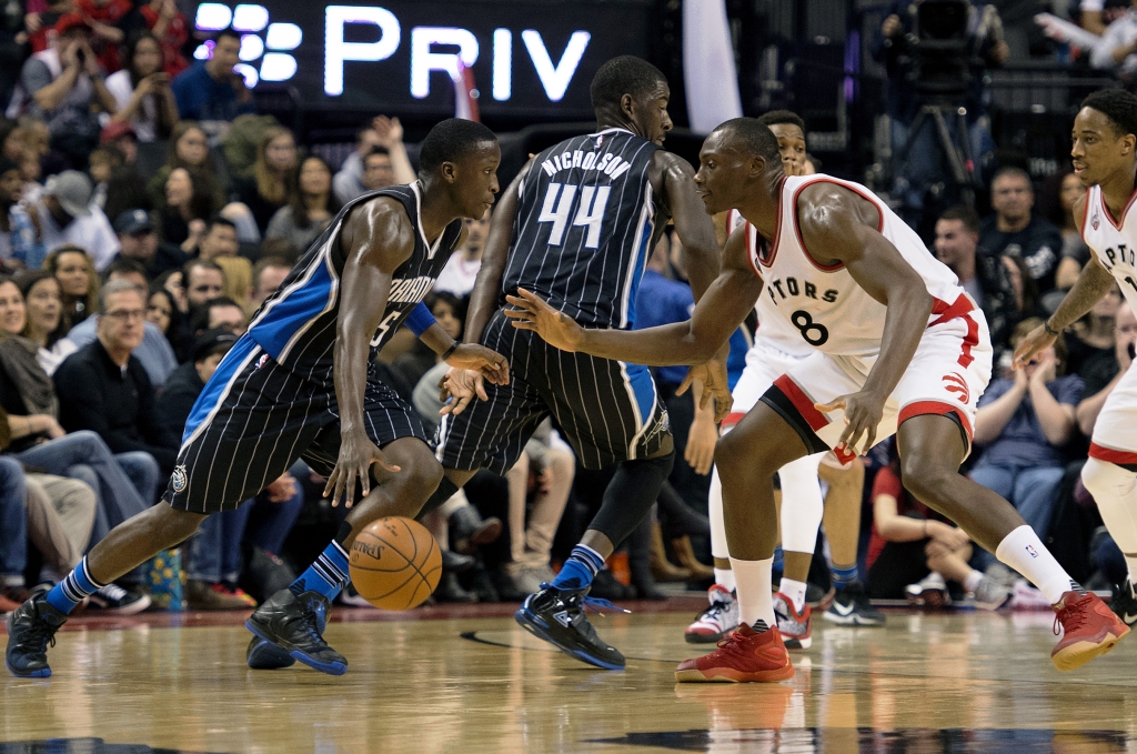 Mar 20 2016 Toronto Ontario CAN Orlando Magic guard Victor Oladipo looks to play a ball as Toronto Raptors center Bismack Biyombo tries to defend during the fourth quarter in a game at Air Canada Centre. The Toronto Raptors won 105-100. Manda