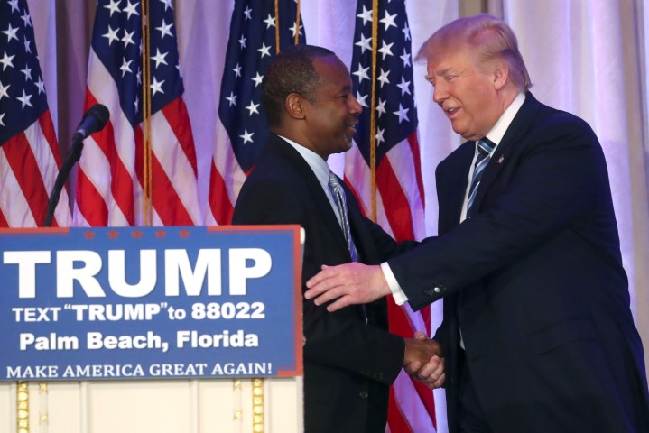 Donald Trump shakes hands with Ben Carson after receiving Carson's endorsement at a campaign event in Palm Beach Florida