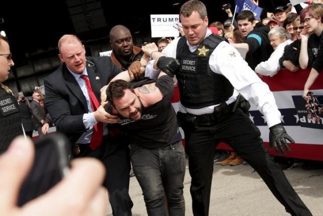 U.S. Secret Service agents detain a man after a disturbance as U.S. Republican presidential candidate Donald Trump spoke at Dayton International Airport in Dayton Ohio