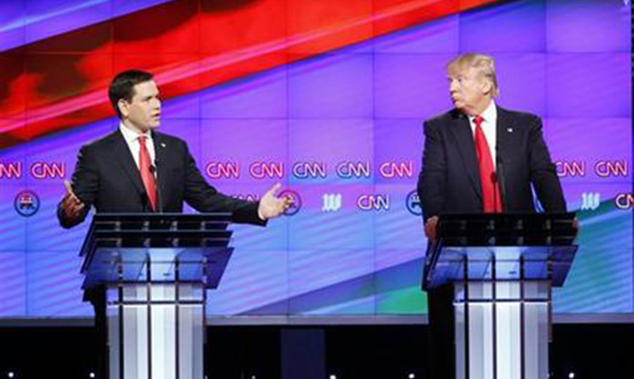 Republican presidential candidate Sen. Marco Rubio R-Fla. left answers a question as Republican presidential candidate businessman Donald Trump listens