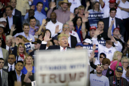 Republican U.S. presidential candidate Donald Trump asks his supporters to raise their hands and promise to vote for him at his campaign rally at the University of Central Florida in Orlando Florida