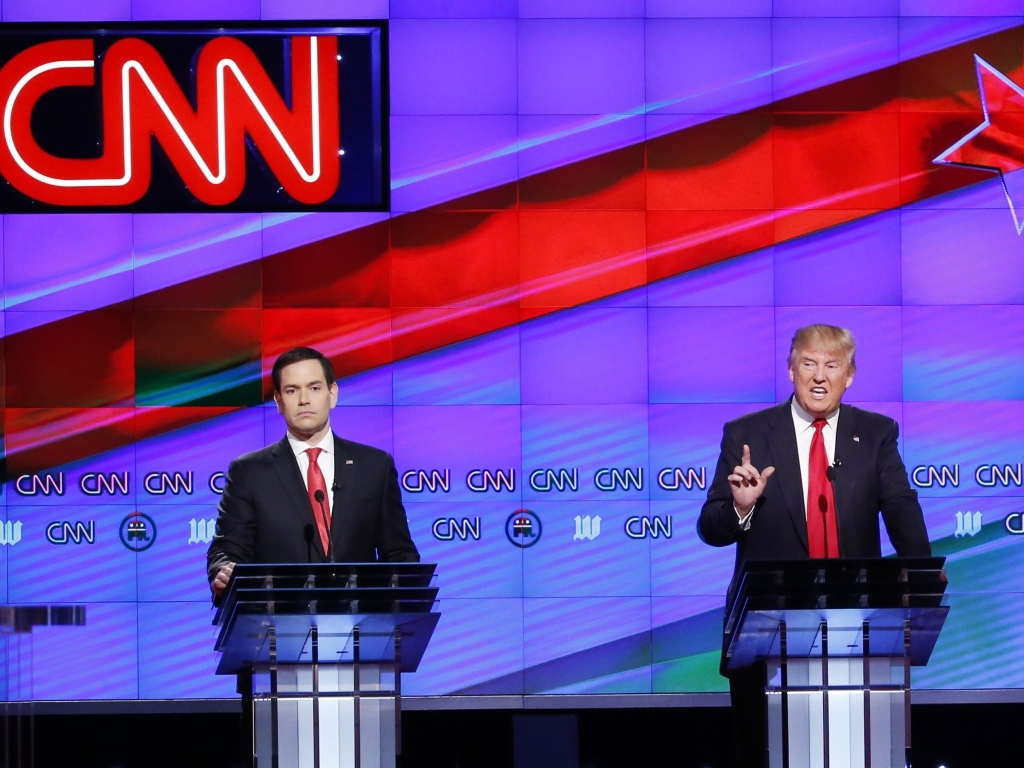 Donald Trump speaks as Sen. Marco Rubio listens during the Republican presidential debate at the University of Miami on Thursday.   Wilfredo Lee    
  AP