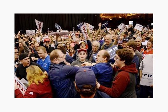 A protester center left and a Trump supporter center right scuffle during a rally for Republican presidential candidate Donald Trump Saturday March 12 2016 held at the I-X Arena in Cleveland Ohio. (Michael Henninger  Pittsburgh Post Gazette via AP