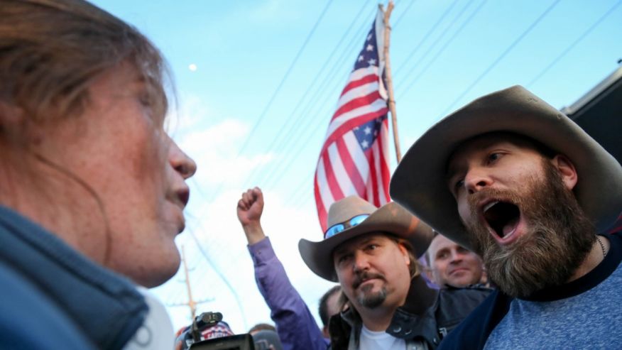 A protester confronts supporters of Republican presidential candidate Donald Trump in downtown Salt Lake City as Donald Trump gave his first campaign speech in Utah