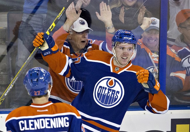 Edmonton Oilers&#039 Connor Mc David and Adam Clendening celebrate McDavid's goal against the Columbus Blue Jackets during second period NHL action in Edmonton Alta. on Tuesday