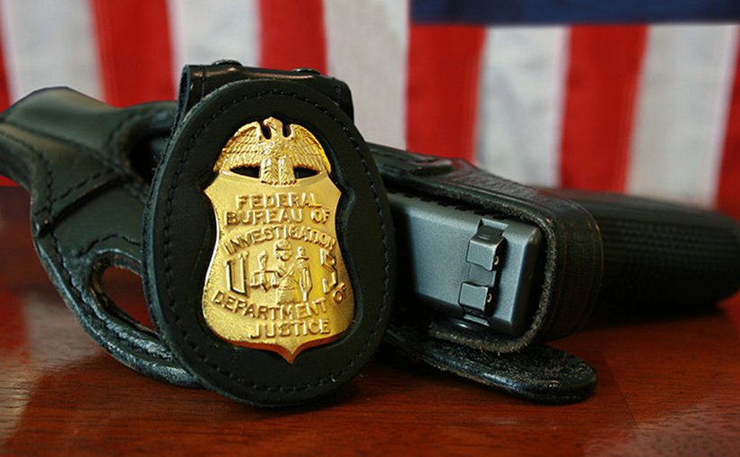 FBI badge and gun. Source Wikipedia Commons