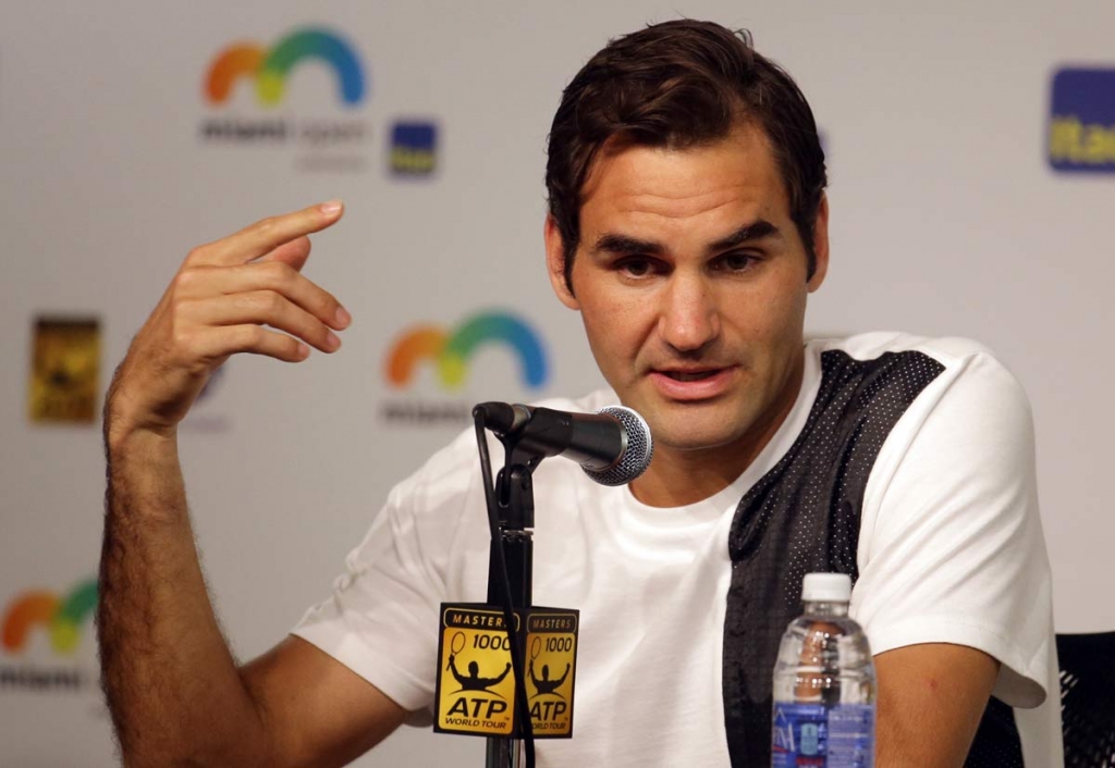 Roger Federer of Switzerland responds to a question during a news conference at the Miami Open tennis tournament Thursday