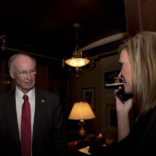 Republican Gov. Robert Bentley listens to a phone call as Rebekah Mason right announces his win for Alabama governor in Montgomery Ala. Bentley defeated his opponent Democrat Parker Griffith. Be