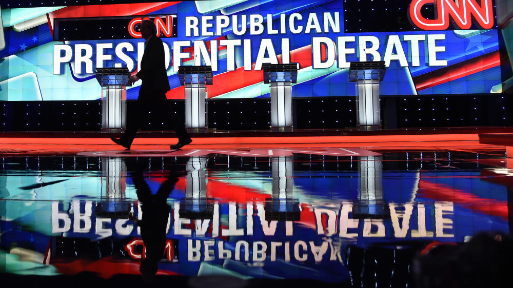 A worker walks across the stage as CNN prepares for the Republican Presidential Debate Thursday in Miami Florida