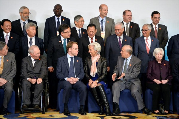 International Monetary Fund Managing Director Christine Lagarde talks with Germany's Federal Bundesbank chief Jens Weidmann before they pose for a family