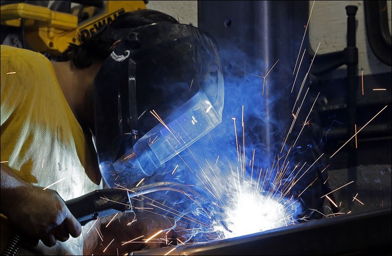 Gabriel Gon-zalez welds a support beam in Hialeah Fla. Factory production was up in February for the second month in a row