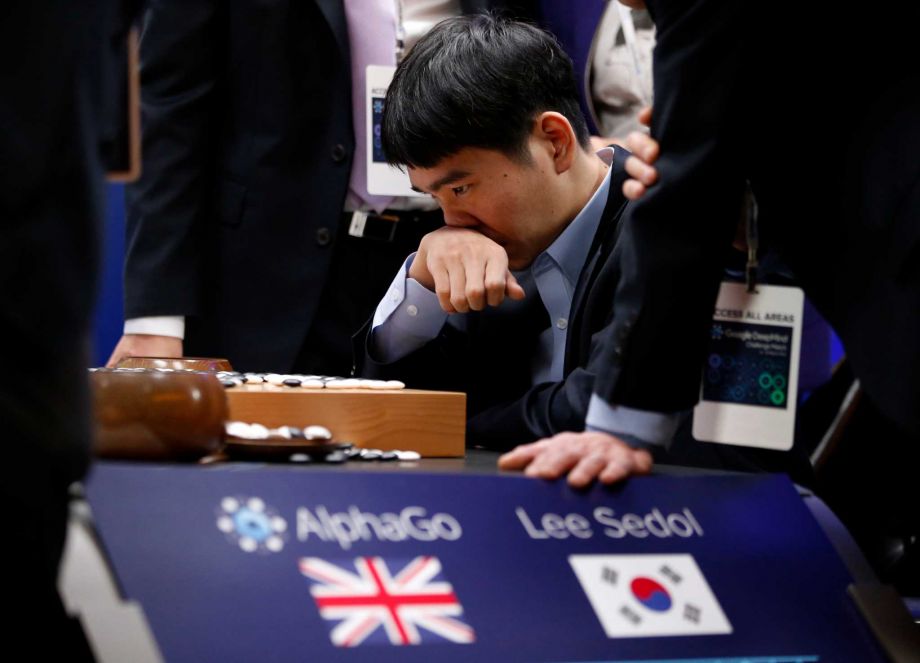 South Korean Go player Lee Sedol reviews the match Tuesday after finishing the final game of the challenge against Google's Go-playing program AlphaGo