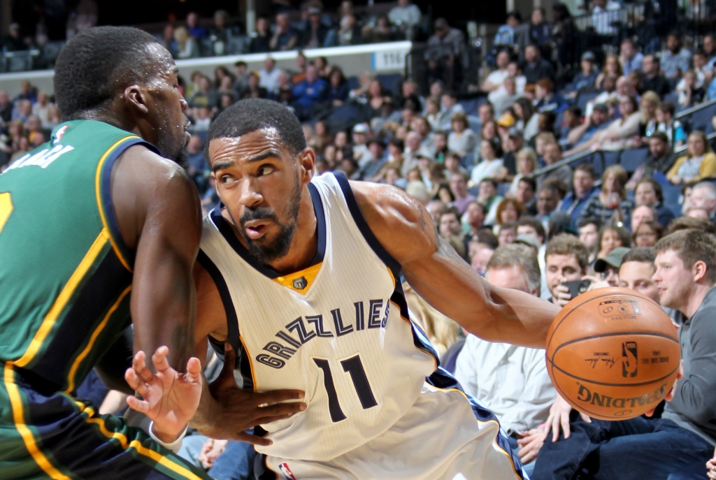 Grizzlies point guard Mike Conley drives to the basket defended by Utah