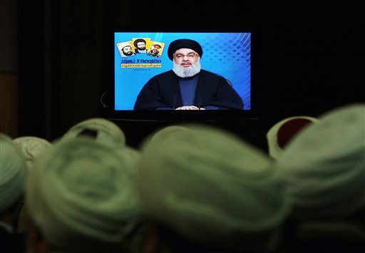 Shiite and Sunni clerics listen to Hezbollah leader Sayyed Hassan Nasrallah as he speaks via a video link during a ceremony to honer fallen Hezbollah leaders in the southern suburbs of Beirut Lebanon. A