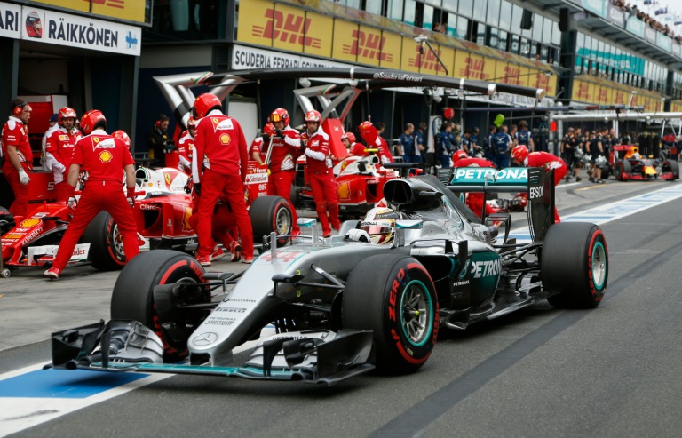 Pool  AFP  Brandon Malone British driver Lewis Hamilton drives past the Ferrari garage during qualifying at the Australian Grand Prix in Melbourne