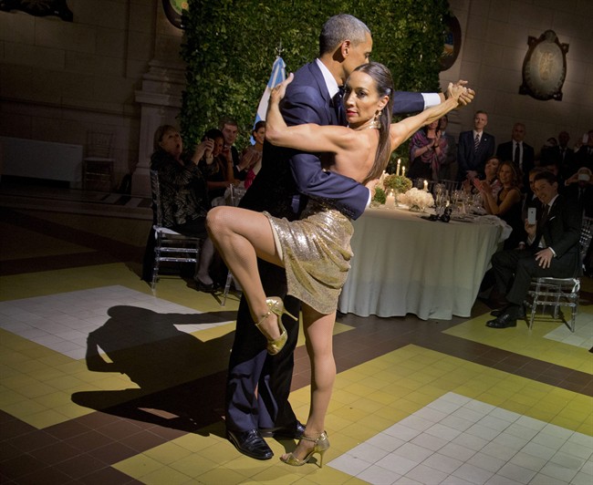 President Barack Obama with does the tango with a dancer during the State Dinner at the Centro Cultural Kirchner Wednesday