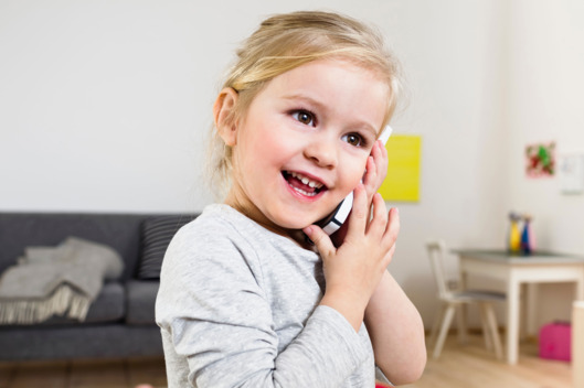 Girl talking on smartphone at home