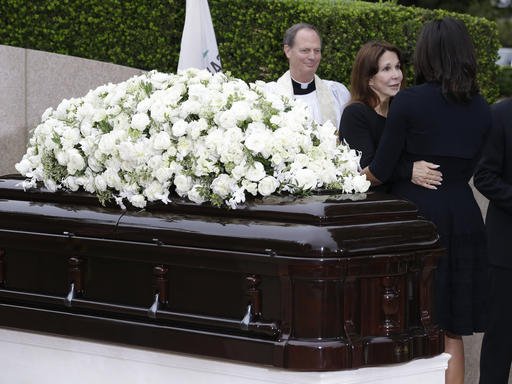 Patti Davis center greets first lady Michelle Obama right during the graveside service for Nancy Reagan at the Ronald Reagan Presidential Library Friday