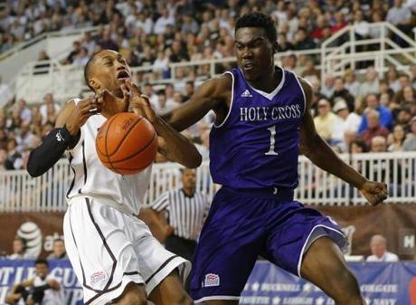 Lehigh guard Kahron Ross left has the ball knocked away from him by Holy Cross forward Karl Charles during the first half of the NCAA college basketball Patriot League Championship game at Lehigh in Bethlehem Pa. Wednesday