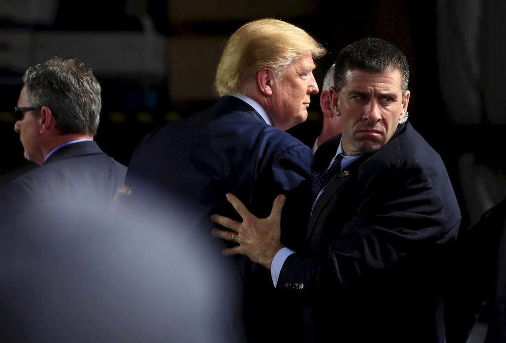 U.S. Secret Service agents surround U.S. Republican presidential candidate Donald Trump during a disturbance as he speaks at Dayton International Airport in Dayton Ohio