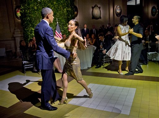 President Barack Obama and first lady Michelle Obama do the tango with dancers during the State Dinner at the Centro Cultural Kirchner Wednesday