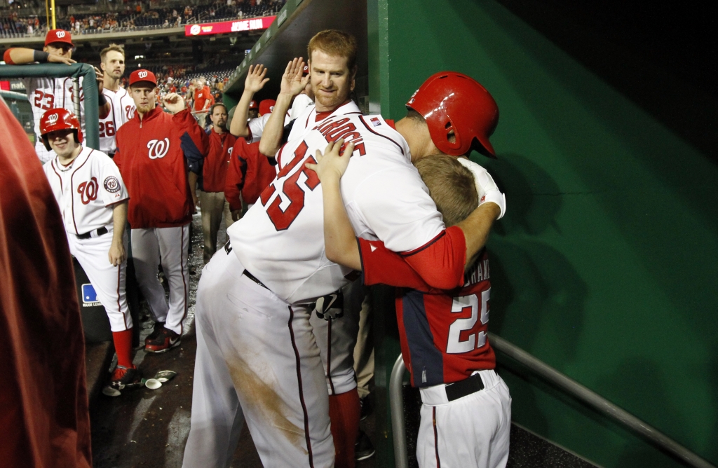 Adam La Roche hugs his son Drake after a home run. AP