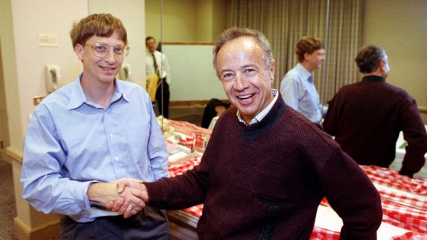 Intel Corp. President Andy Grove right shakes hands with Microsoft Chairman Bill Gates at a meeting in Burlingame Calif. in 1992