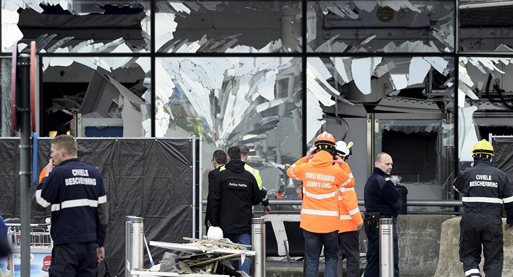 Broken windows of the terminal at Brussels national airport are seen during a ceremony following bomb attacks in Brussels metro and Belgium's National airport of Zaventem Belgium