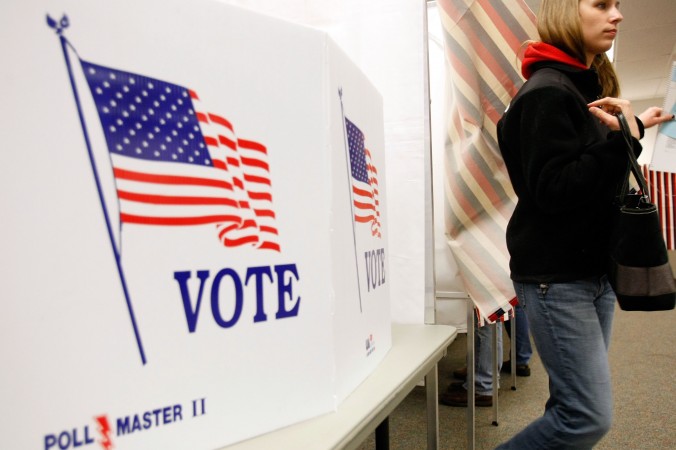 New Hampshire resident leaves a voting booth after casting her vote in the New Hampshire presidential primary at the Ward 3 Carol M. Rines Center