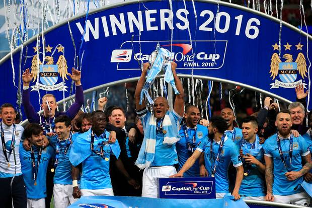 Just champion City’s Vincent Kompany lifts the League Cup