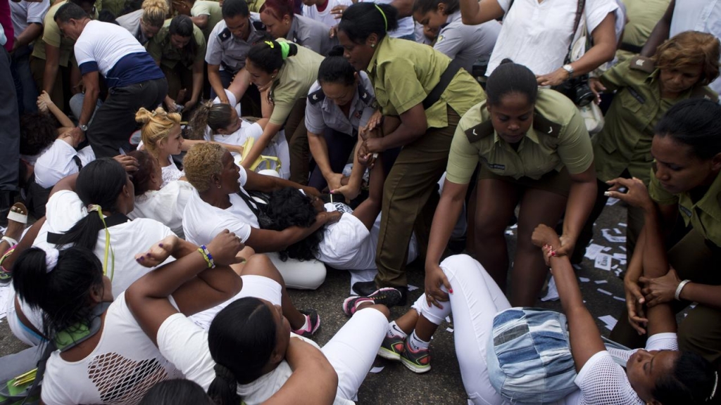 Just hours before Barack Obama s visit to Cuba police have dispersed a protest by Ladies in White