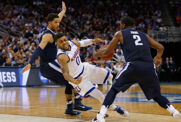 Jayhawks Frank Mason III falls while driving between Josh Hart and Kris Jenkins of Villanova