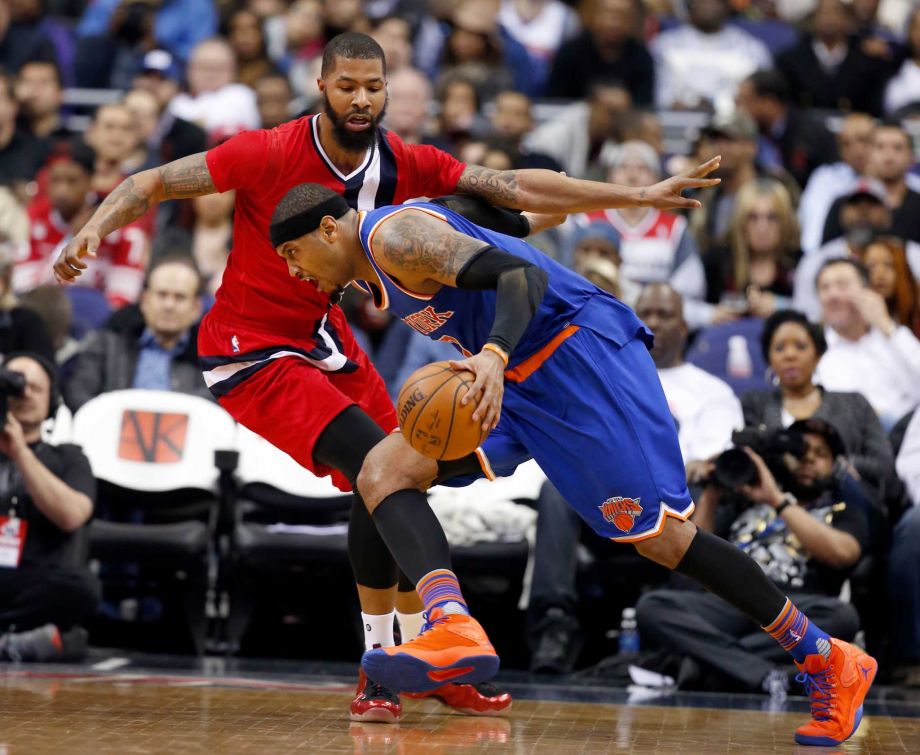 New York Knicks forward Carmelo Anthony drives against Washington Wizards forward Markieff Morris during the second half of an NBA basketball game Saturday