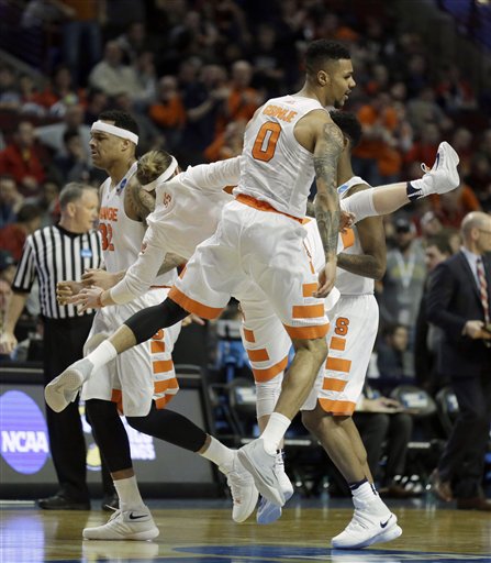 Syracuse's Michael Gbinije and Syracuse's Christian White celebrate after a play during the second half of a college basketball game against Gonzaga in the regional semifinals of the NCAA Tournament Friday