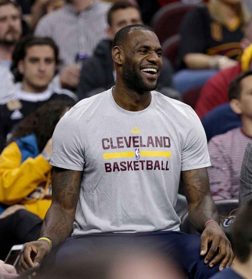 Cleveland Cavaliers Le Bron James laughs as he sits on the bench in the first half of an NBA basketball game against the Dallas Mavericks Wednesday