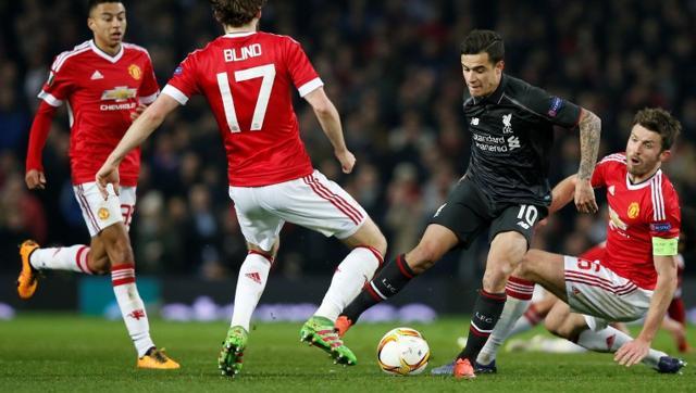 Liverpool's Philippe Coutinho in action with Manchester United's Michael Carrick and Daley Blind