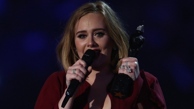 Adele cries as she accepts her award for global success at the 2016 Brit Awards in London on Wednesday. The singer famously called the Queen of the Brits took home four awards in the British equivalent of the Grammy Awards