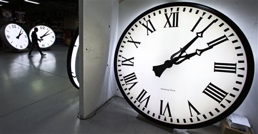 Tom Liberatore a materials purchasing manager walks past clocks being tested prior to shipping at the Electric Time Company in Medfield Mass. Thursday