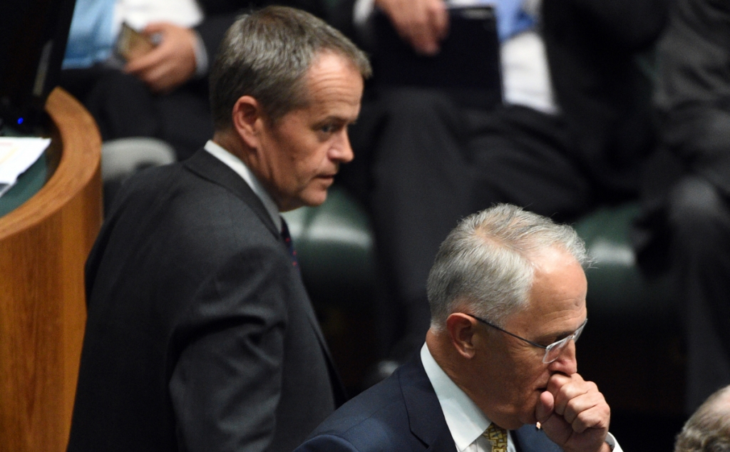 Leader of the Opposition Bill Shorten looks back at Prime Minister Malcolm Turnbull after a division during Question Time at Parliament House in Canberra on Wednesday