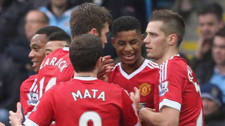 Marcus Rashford celebrates with team-mates after scoring the winner